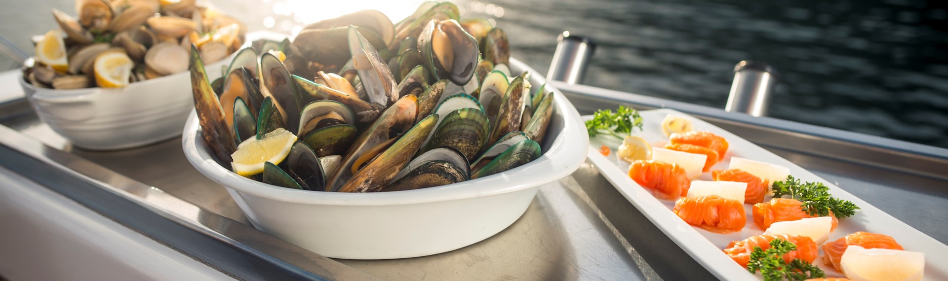 Cloudy Bay Clams, Greenshell mussels and Regal salmon are served at the source on a Seafood Odyssea cruise in New Zealand's spectacular Marlborough Sounds from Picton.